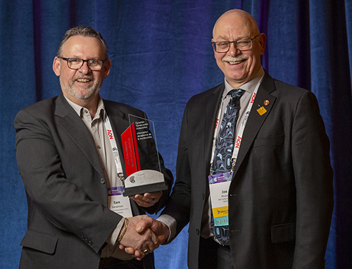 From left to right: Sam Sanderson, Construction Association of PEI’s general manager, is congratulated by Joe Wrobel on being awarded with the Partner Association Award.